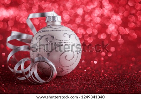 Christmas composition of Christmas tree toys on a blurred red background