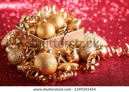 Christmas composition of Christmas tree toys on a blurred red background