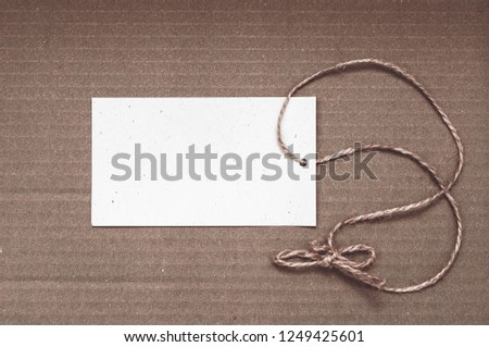 Paper label with rope on brown background. Empty