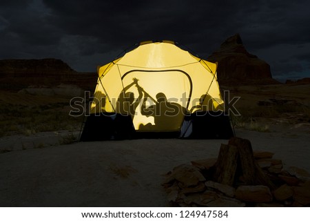 Shadow of young people sitting together in tent