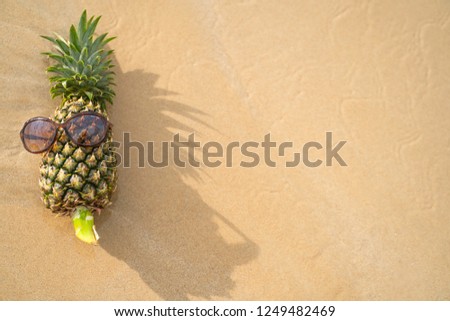 Pineapple Holiday with glasses  ,Concept cheesy chill relaxed on the beach Tropical design made in Phuket, Thailand.
