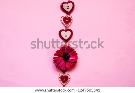 Love or Valentines Day concept. Creative paper background with hearts. Pink trendy color.Holiday and celebration concept for postcard or invitation. Top view, copy space, closeup.