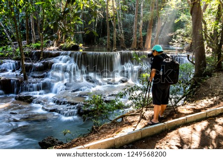Photographer taking photo of Beautiful of Huai Mae Khamin waterfall at Kanchanaburi, Thailand  with tree forest background. Waterfall Floor 6 "Dongpheserl"