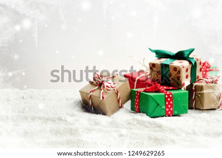 Small Handmade gift boxes in in the snow.Christmas holiday celebration concept.