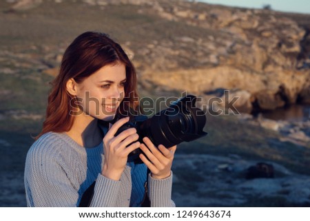 Woman with a camera in nature                      