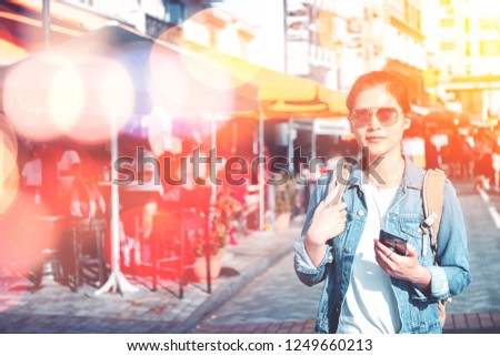 Young woman traveling on Stanley Market in Hong Kong with bokeh light effect