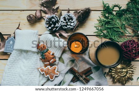 cup of coffee and  winter composition Flat lay top view vintage toys on the background of winter leaves Cozy home atmosphere beautiful composition with  candle