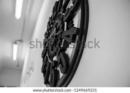 A black and white pic of a clock taken in a dance school in italy