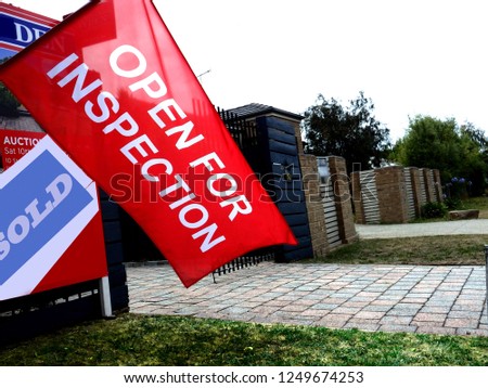 Open for inspection red flag sign in a suburban street
