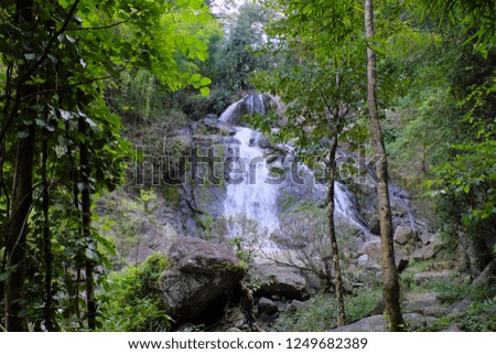 Waterfall with fresh green tropical rain forest trees at Maewa national park, Thoen district, Lampang province, Thailand.