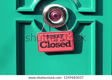 closed sign hanging in a shop door
