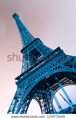 View of the Eiffel tower at sunrise, Paris. Blue toned image.