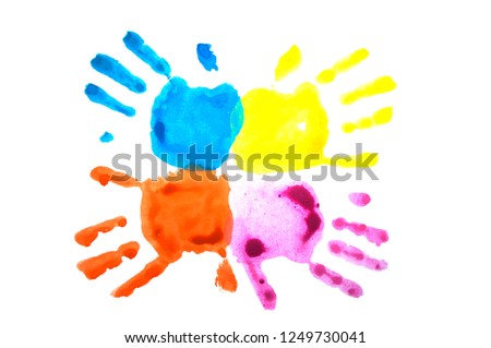 Four colorful child's handprints isolated on white. World autism awareness day concept.