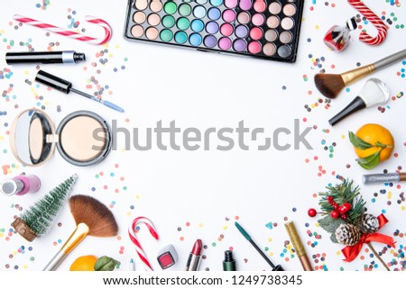Picture on top of eye shadows, brushes, , tangerine, sugar cane on empty white table