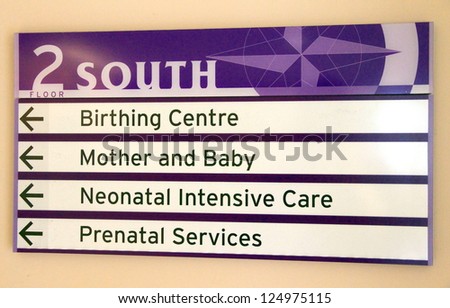 Sign indicating different departments at a hospital