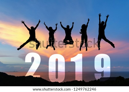 Silhouette happy business teamwork jumping congratulation graduation in Happy New year 2019. Freedom lifestyle group people jump as part of Number 2019 at the sunset beach, copy space.
