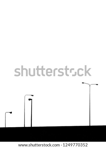 silhouette of street lamp post on expressway