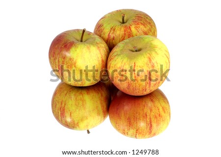 Three Cox apples reflected in a mirror. Royalty-Free Stock Photo #1249788