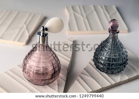 Perfume minimalism glass jars on broken tiles