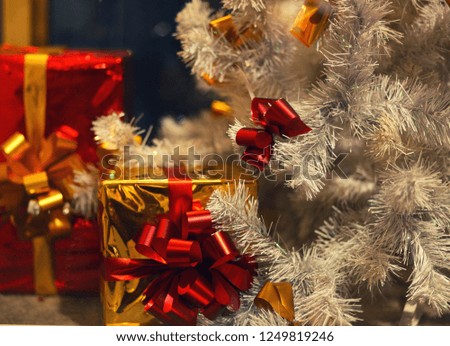 christmas tree and colourful gifts with ribbons/ close up