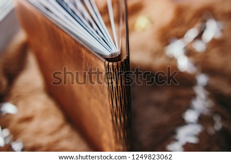 Binding wooden photo books with plastic pages