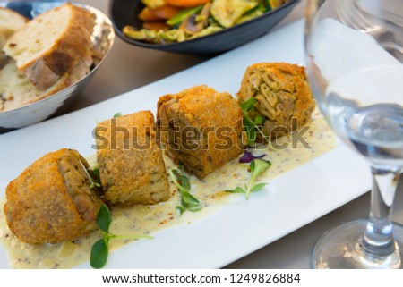Dish of andouillette artisanale served at plate on cafe, french cuisine