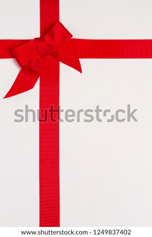 Layout made of red ribbon bow on white background. Mockup, flat lay
