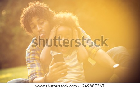 Let your memories be full of happiness. African American father and daughter taking self portrait in nature.