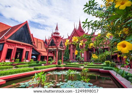 Exterior of traditional Khmer architecture and beautiful courtyard of the National Museum of Cambodia, lush pond with fresh flowers. Phnom Penh City. Bright sunlight. The museum is open to the public.