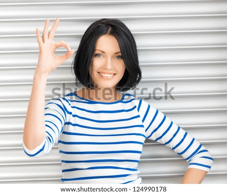 picture of happy teenage girl showing ok sign