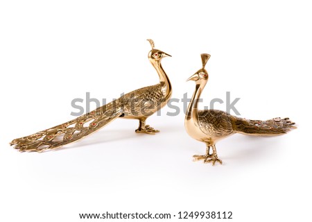 Vintage metal bird figurines on white background