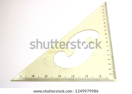 Triangular transparent ruler that is characterized by being used on a white background.