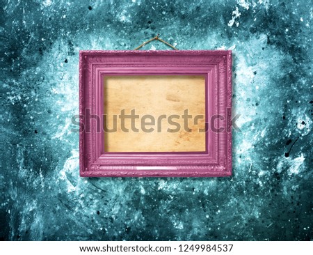 Old vintage multicolored ornate frame for picture on grunge stone wall