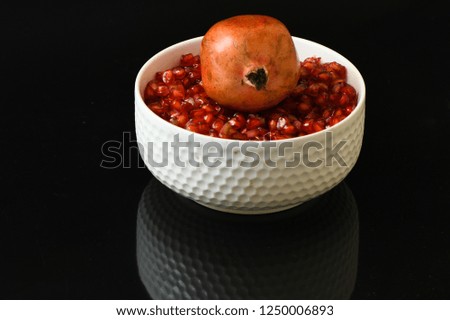 pomegranate seeds fruits in white glass cup red closeup protein healthy vegetarian food black background sweet food