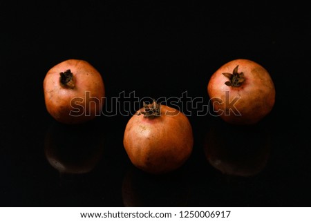 pomegranate fruits seeds on isolated black background closeup protein food red color closeup shot