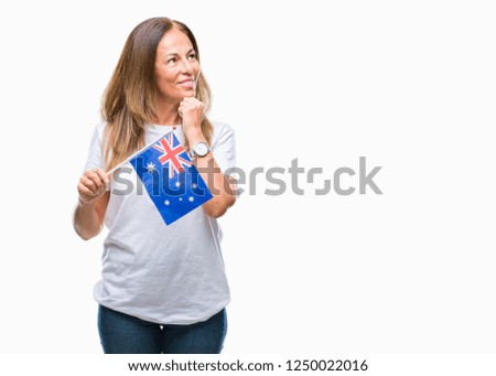Middle age hispanic woman holding flag of Australia over isolated background serious face thinking about question, very confused idea