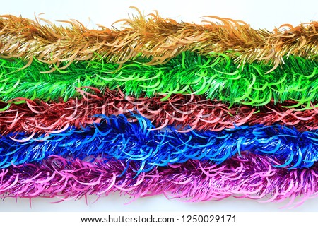 Multi colors bunch fur or Christmas tree tinsel garland on white background. Christmas and New year celebration.