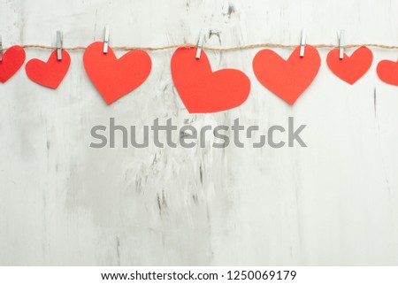 Valentine background with red hearts on clothespins on a white background. Happy baby day card mock up, copy space