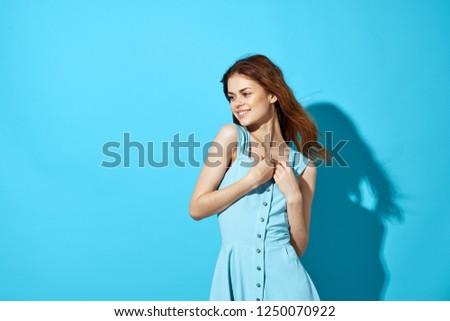 Beautiful woman in blue dress is smiling                  