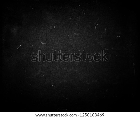 Black scratched grunge background, dusty texture, space for your text or picture, old film effect