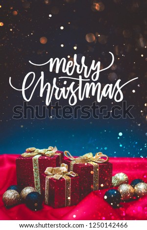Sparkly red present boxes with Christmas lights on a red and blue background with bokeh and Merry Christmas quote
