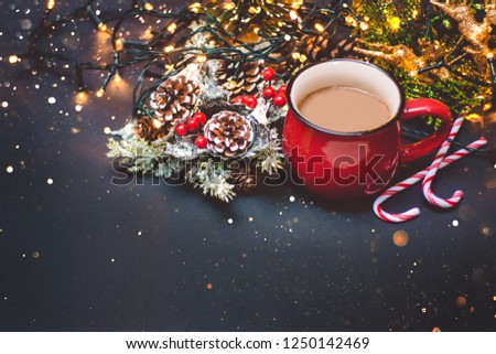 A coffee in a red cup with Christmas lights, bokeh and decoration
