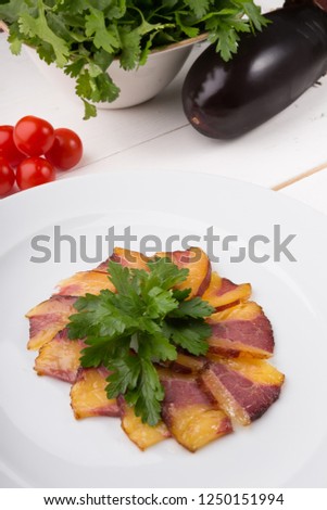 Smoked horse meat sliced and served on a plate
