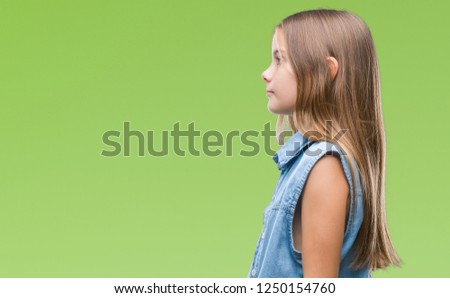 Young beautiful girl over isolated background looking to side, relax profile pose with natural face with confident smile.