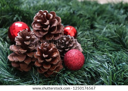 Christmas and New Year background with pine cones, tree and red Christmas balls
