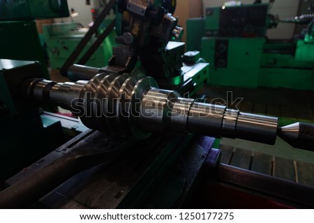 Grinding of the worm shaft on the backing machine. Industrial industry manufacturing gear shafts.