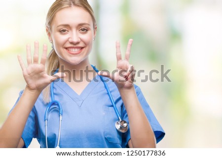 Young blonde surgeon doctor woman over isolated background showing and pointing up with fingers number eight while smiling confident and happy.