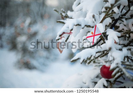Jersey flag. Christmas background outdoor. Xmas tree covered with snow and decorations and a national flag. Christmas and New Year holiday greeting card.