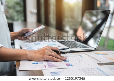 Business woman accountant working audit and calculating expense financial annual financial report balance sheet statement, doing finance making notes on paper checking document. Royalty-Free Stock Photo #1250197345