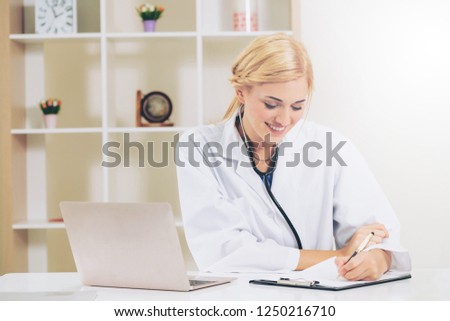 Young female doctor working in hospital office. Medical and healthcare concept.